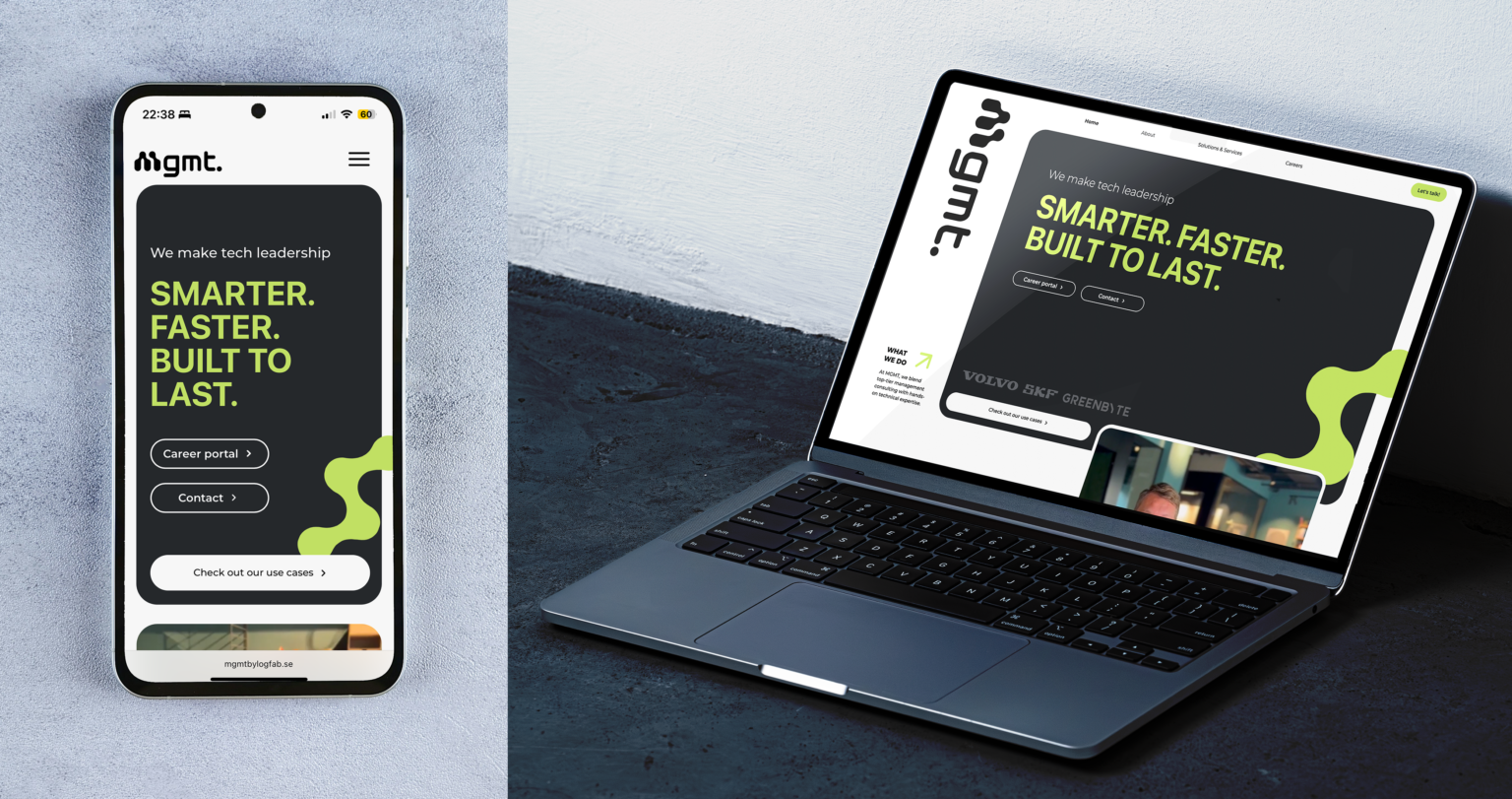 A mockup featuring a mobile and a desktop layout of Mgmts new website. The laptop is resting on a concrete surface and the mobile phone is a cutout.